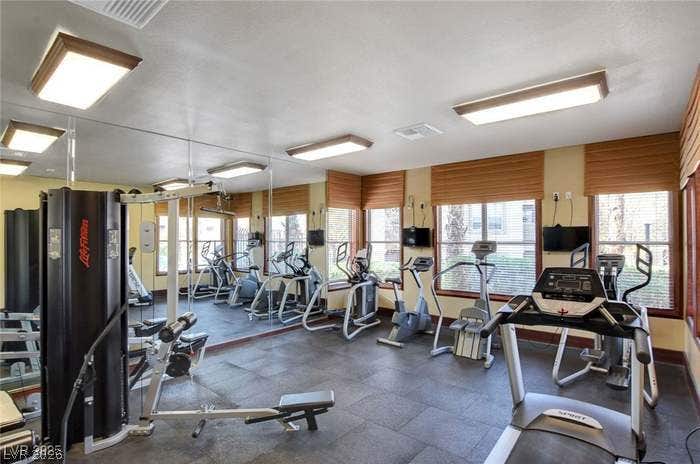 2300 E Silverado Ranch Boulevard, #1077, Las Vegas, NV 89183 Mirrored walls and expansive windows create an inviting atmosphere in this well-appointed fitness center.