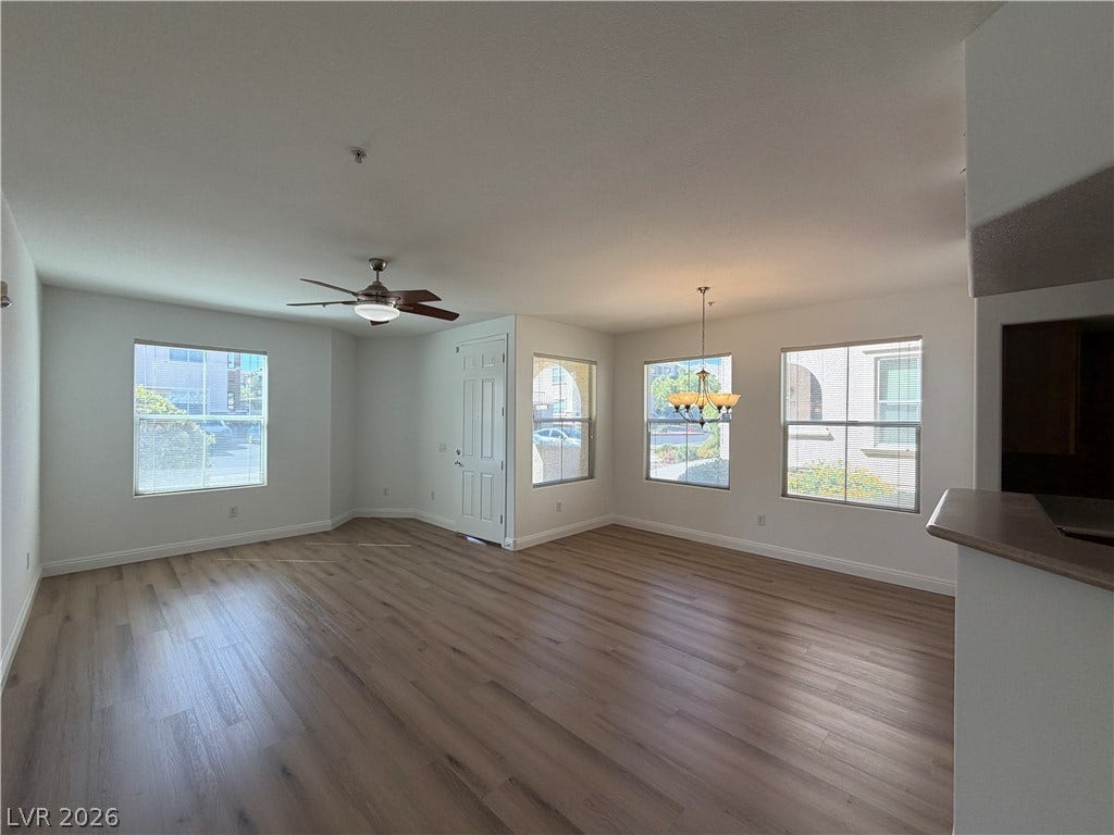 8777 W Maule Avenue, #1158, Las Vegas, NV 89148 Gleaming wood-look floors anchor a versatile, light-filled living area designed for easy living.