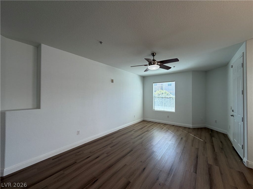 8777 W Maule Avenue, #1158, Las Vegas, NV 89148 Warm wood-style flooring runs through this versatile room under a tall smooth ceiling.