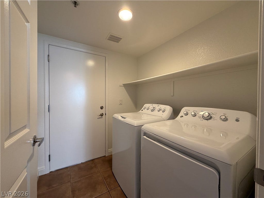8777 W Maule Avenue, #1158, Las Vegas, NV 89148 A dedicated laundry space features durable tile flooring and overhead storage shelving.
