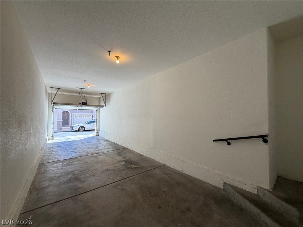 8777 W Maule Avenue, #1158, Las Vegas, NV 89148 Concrete flooring and high ceilings define this attached garage space with direct interior access.