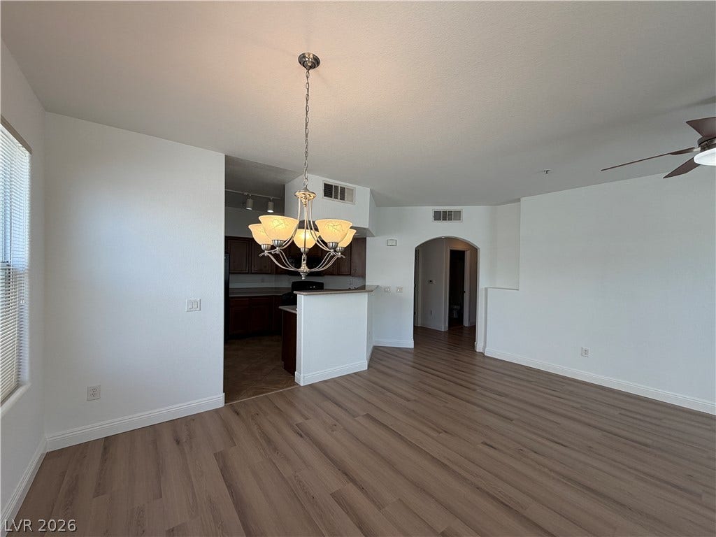 8777 W Maule Avenue, #1158, Las Vegas, NV 89148 An open floorplan seamlessly connects the dining space to the kitchen over durable wood flooring.