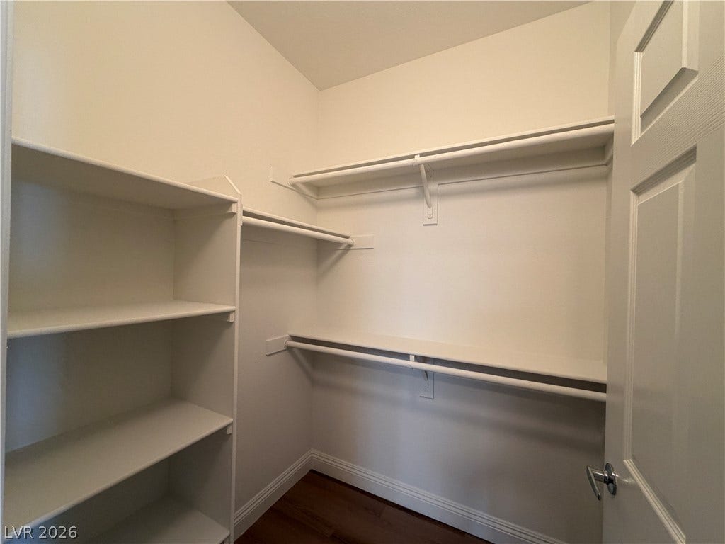 8777 W Maule Avenue, #1158, Las Vegas, NV 89148 Ample built-in shelving and hanging rods maximize storage in this wood-floored closet.