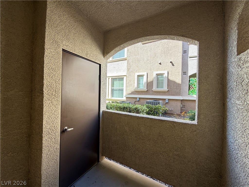 8777 W Maule Avenue, #1158, Las Vegas, NV 89148 Stucco arches frame views of the community from this covered private entry.