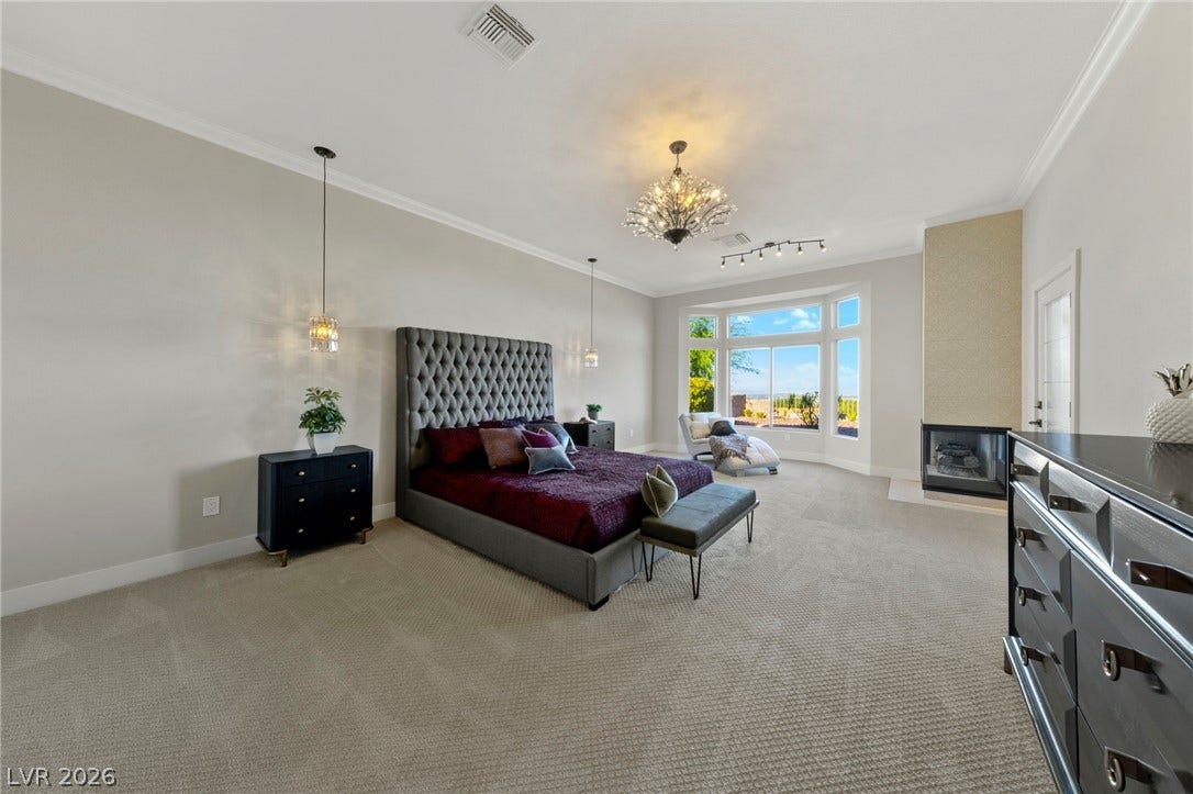 Stepping Inside the Master Bedroom Featuring a Double Sided Fireplace, Blue Sky Views and Sweeping Views of the Entire Valley....