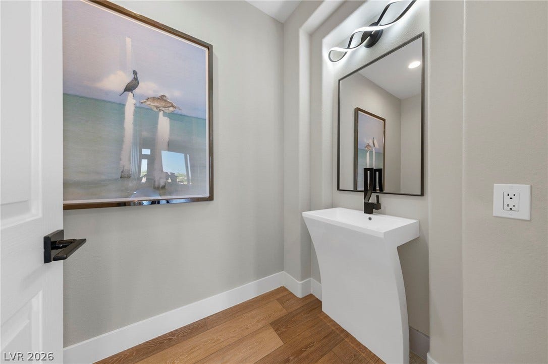 Powder Room Featuring Custom Water Fall Sink finished with Matching Mirror, Light Fixture and Faucet....