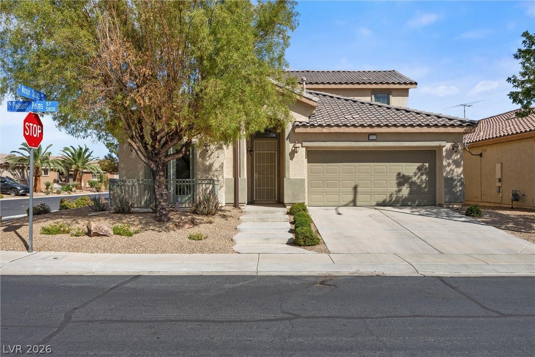 5824 Pleasant Palms Street, North Las Vegas, NV 89081 Tile roofing and stucco finishes define this multi-level home complete with an attached two-car garage.