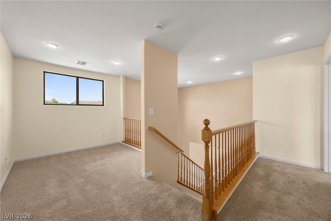 5824 Pleasant Palms Street, North Las Vegas, NV 89081 Recessed lighting and soft carpeting define this versatile upper-level landing space.