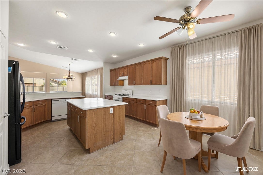 5824 Pleasant Palms Street, North Las Vegas, NV 89081 Gleaming tile floors anchor an open kitchen layout with rich cabinetry and a central island.