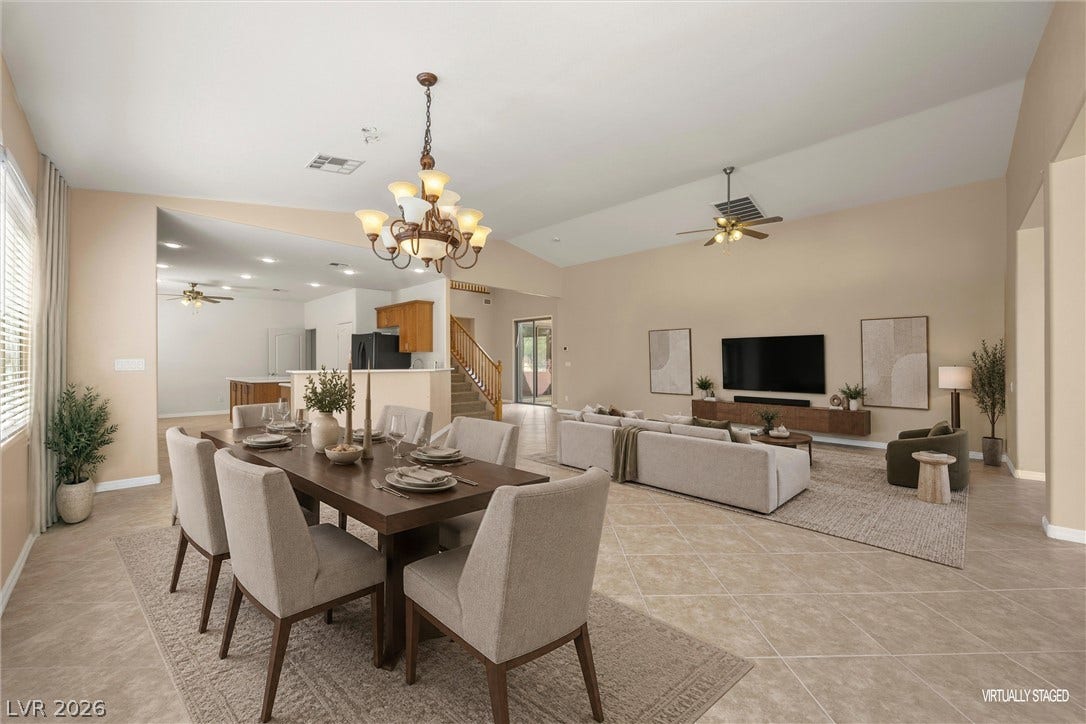 5824 Pleasant Palms Street, North Las Vegas, NV 89081 Vaulted ceilings and tile flooring enhance this open-concept layout connecting dining and living areas.