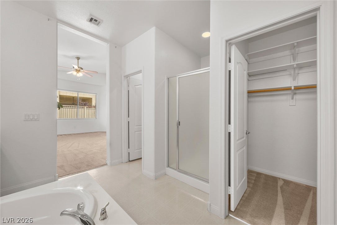 5824 Pleasant Palms Street, North Las Vegas, NV 89081 An ensuite layout connects a tile-floored bathroom to a walk-in closet and bedroom.