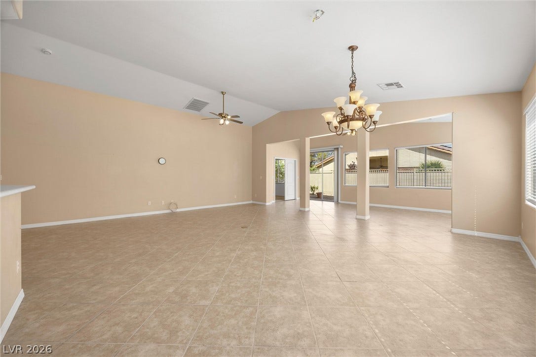 5824 Pleasant Palms Street, North Las Vegas, NV 89081 Gleaming tile floors and vaulted ceilings anchor this versatile open-concept living area.