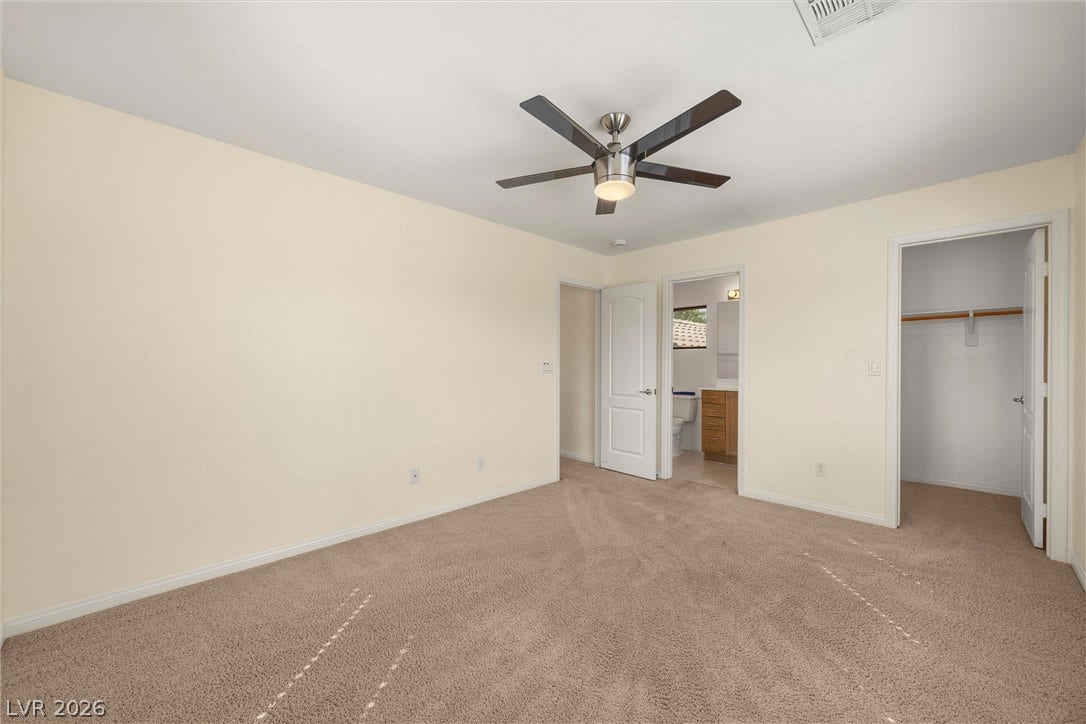 5824 Pleasant Palms Street, North Las Vegas, NV 89081 Plush carpeting and a neutral palette define this comfortable bedroom space.