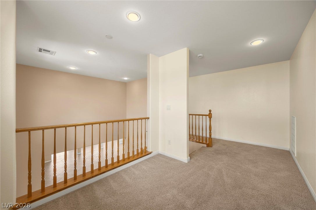 5824 Pleasant Palms Street, North Las Vegas, NV 89081 An open upper-level loft features wall-to-wall carpeting and recessed lighting.