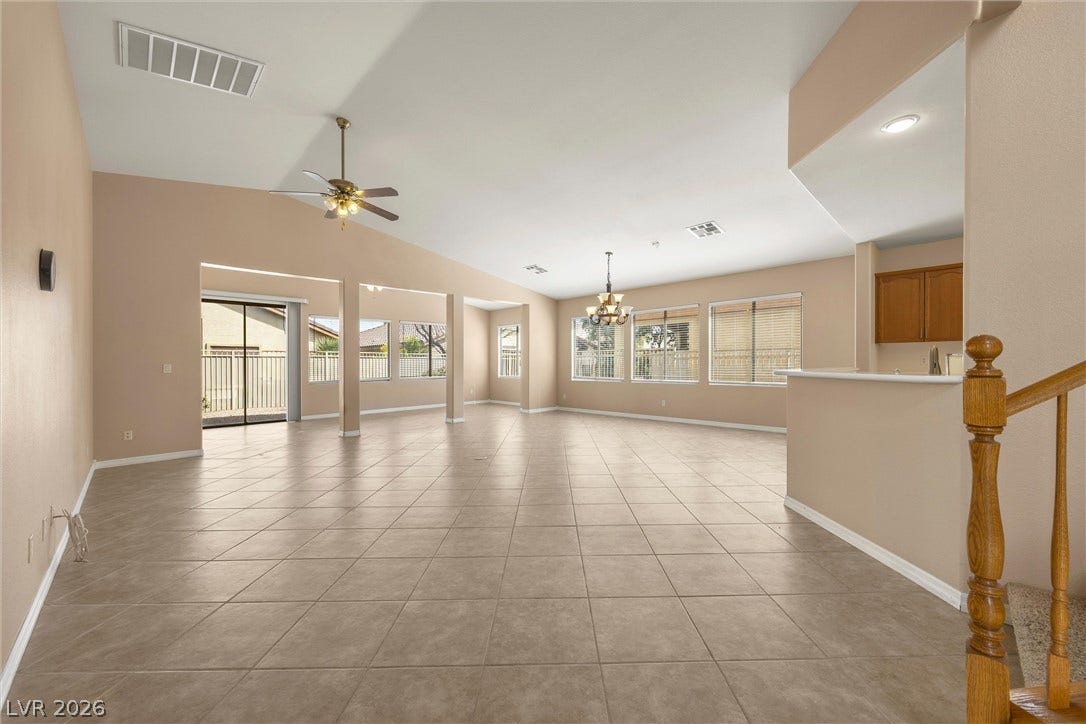 5824 Pleasant Palms Street, North Las Vegas, NV 89081 A spacious, tile-floored living area unfolds beneath vaulted ceilings, leading seamlessly to the kitchen.