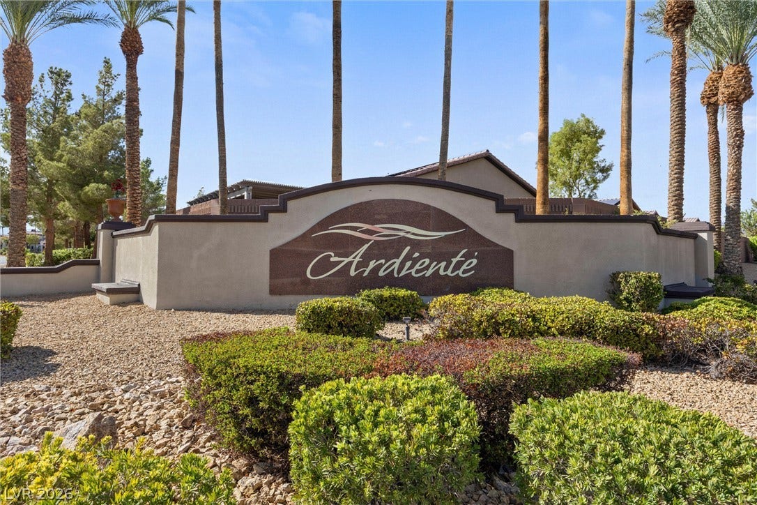5824 Pleasant Palms Street, North Las Vegas, NV 89081 Mature palms frame the entrance monument stone nestled in xeriscape landscaping.