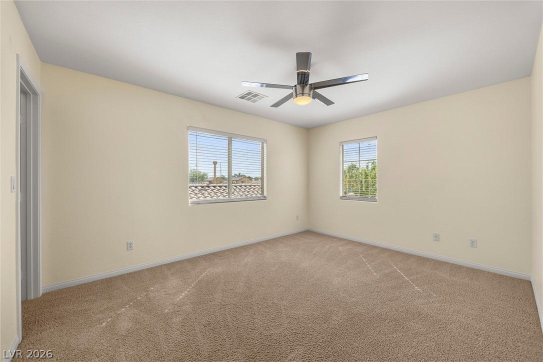 5824 Pleasant Palms Street, North Las Vegas, NV 89081 Plush carpeting and dual windows illuminate this versatile secondary bedroom space.