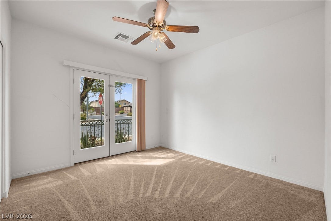5824 Pleasant Palms Street, North Las Vegas, NV 89081 Bedroom 2 down stairs: Plush carpeting and French doors opening to the outdoors define this versatile space.