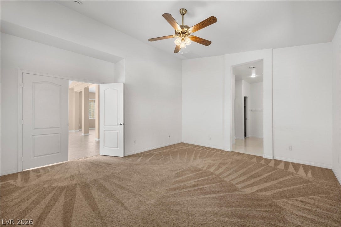 5824 Pleasant Palms Street, North Las Vegas, NV 89081 Double doors open to a carpeted room featuring elevated ceilings and clean plaster walls.