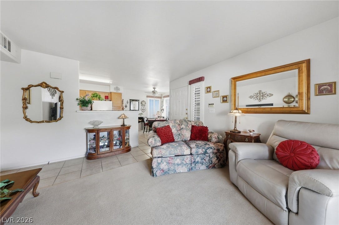 Living room open to dining and kitchen.