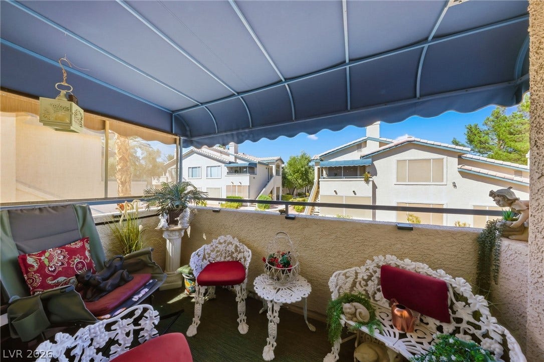 Covered balcony overlooking interior area.