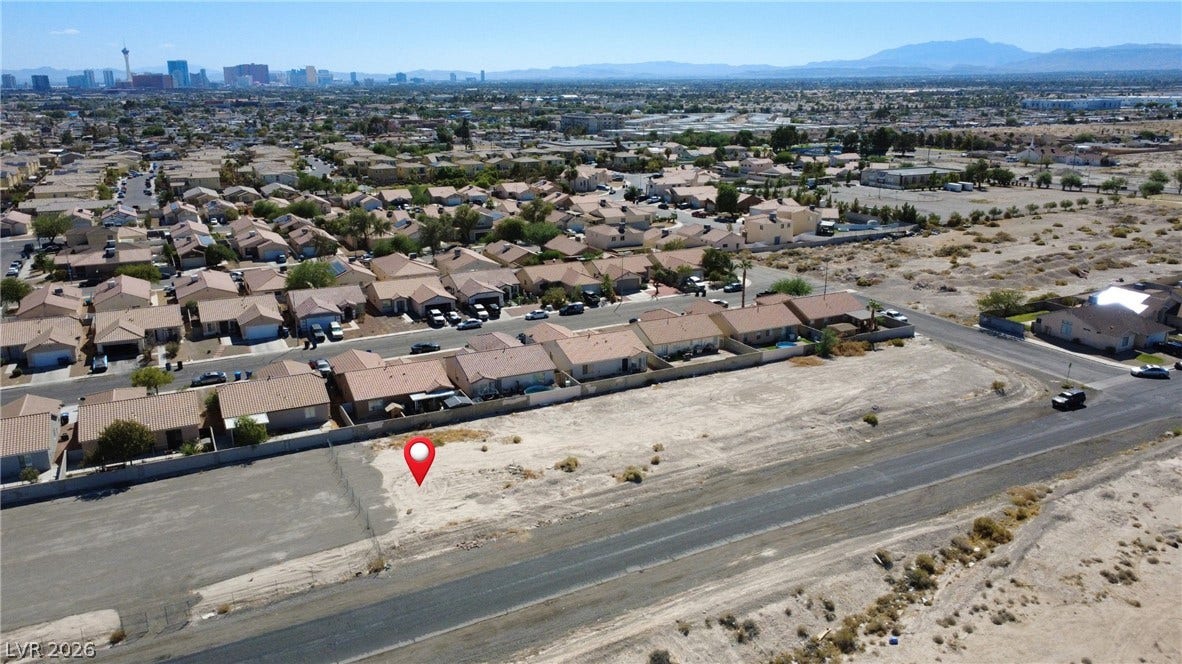 0 Reverend Wilson Drive, North Las Vegas, NV 89030 A spacious vacant lot sits prepared for construction within an established desert community.