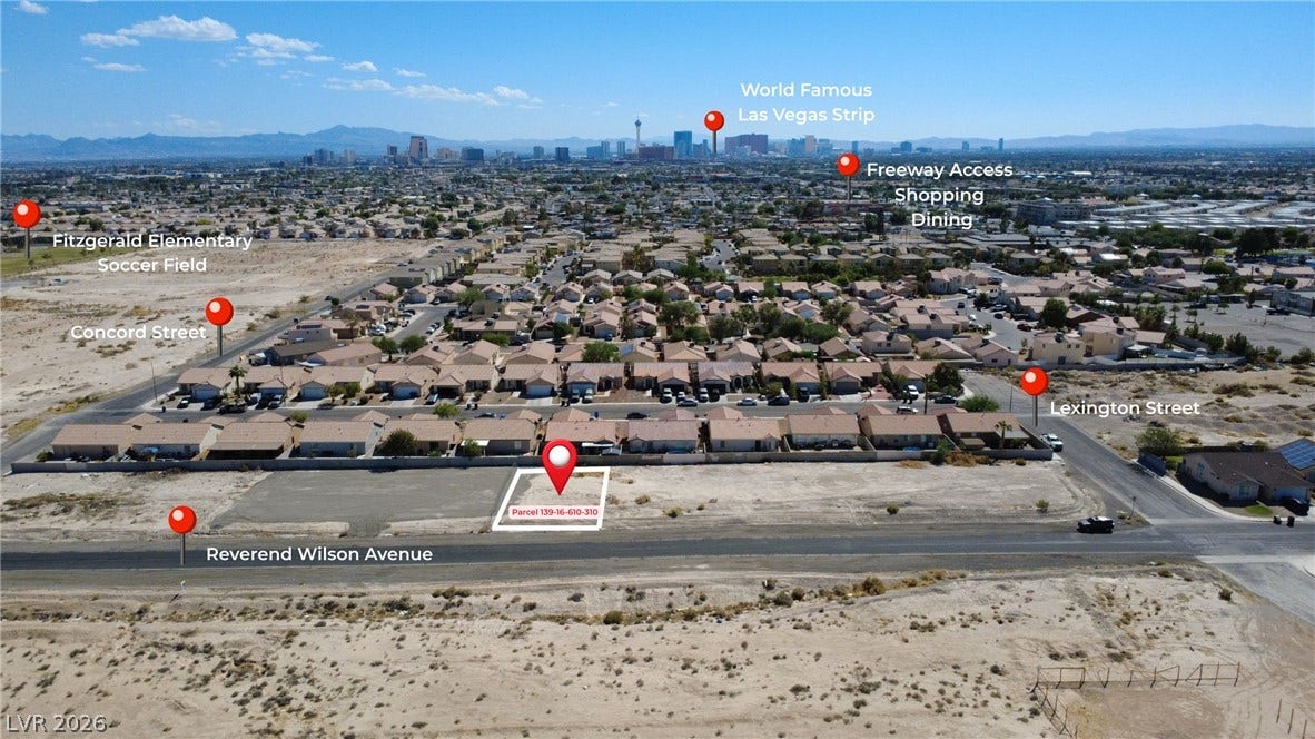 0 Reverend Wilson Drive, North Las Vegas, NV 89030 Aerial view highlights the expansive neighborhood lot set against a distant skyline backdrop.