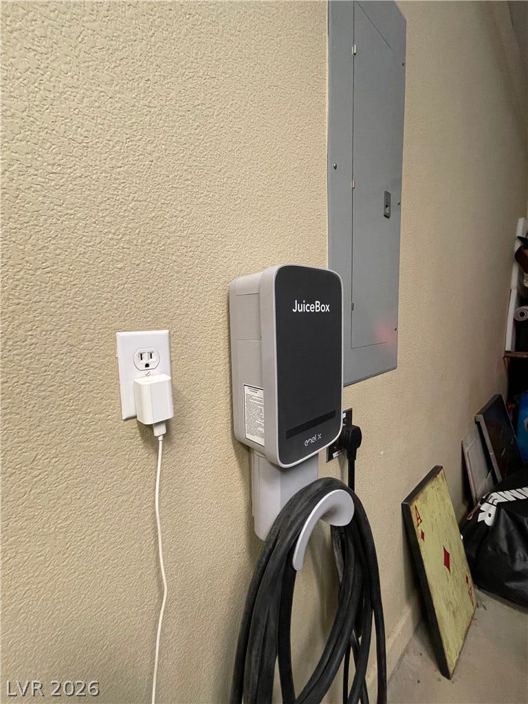 30 Via Vasari, #102, Henderson, NV 89011 An electric vehicle charging station is conveniently mounted alongside the home electrical panel.