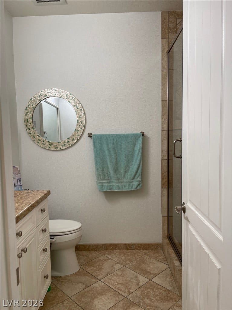 30 Via Vasari, #102, Henderson, NV 89011 A glass-enclosed shower and tile flooring highlight this bathroom.