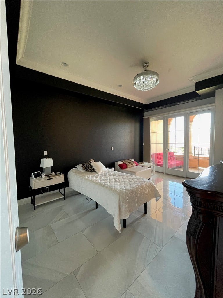 30 Via Vasari, #102, Henderson, NV 89011 Gleaming tile floors and double glass doors opening to a private balcony define this room.