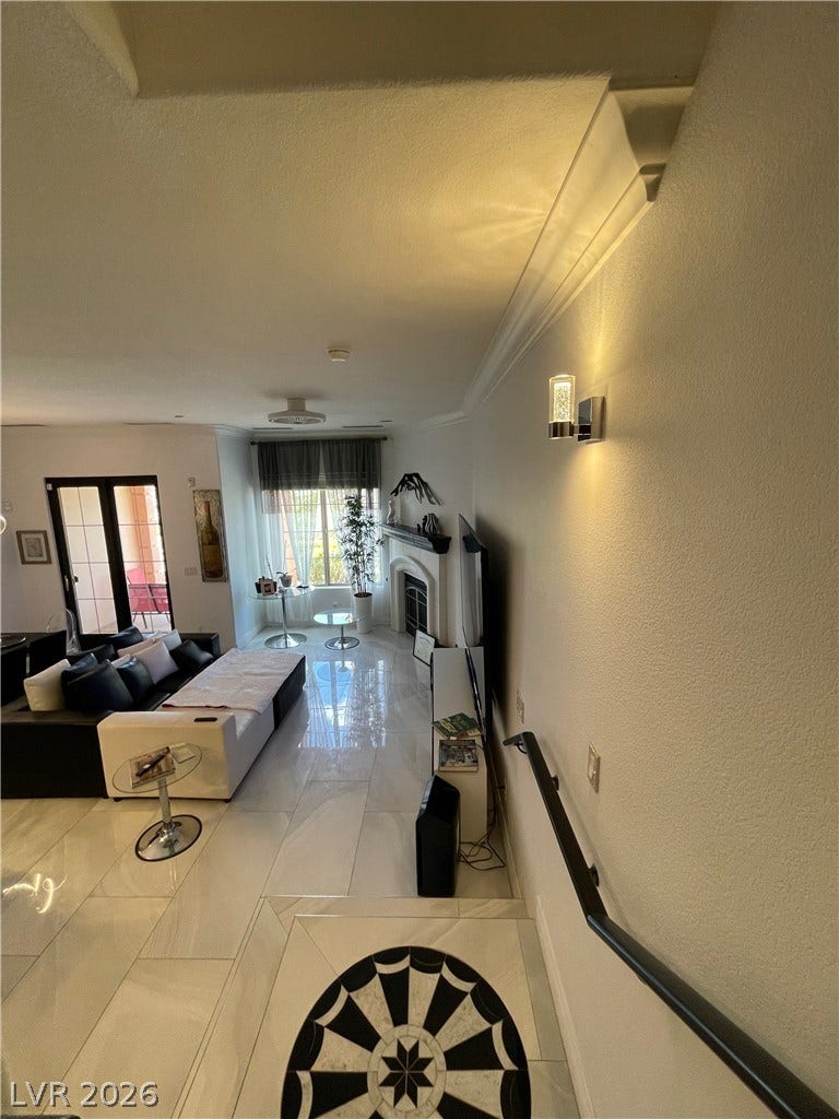 30 Via Vasari, #102, Henderson, NV 89011 Polished tile flooring and architectural crown molding elevate this open-concept main level.