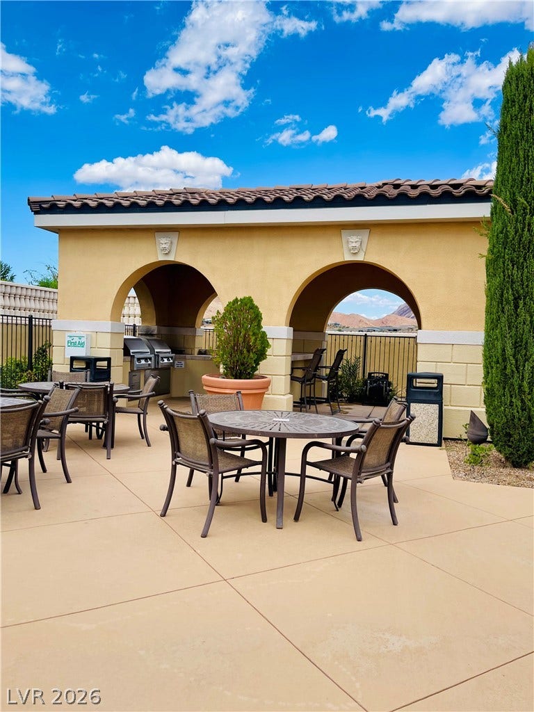 30 Via Vasari, #102, Henderson, NV 89011 An arched stucco pavilion shelters outdoor cooking facilities adjacent to a spacious tiled patio.