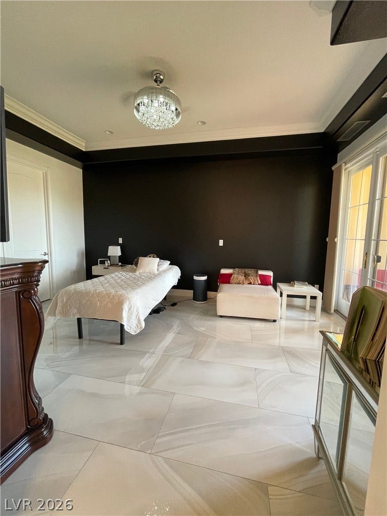 30 Via Vasari, #102, Henderson, NV 89011 Polished tile flooring and crown molding enrich this spacious bedroom featuring direct patio access.