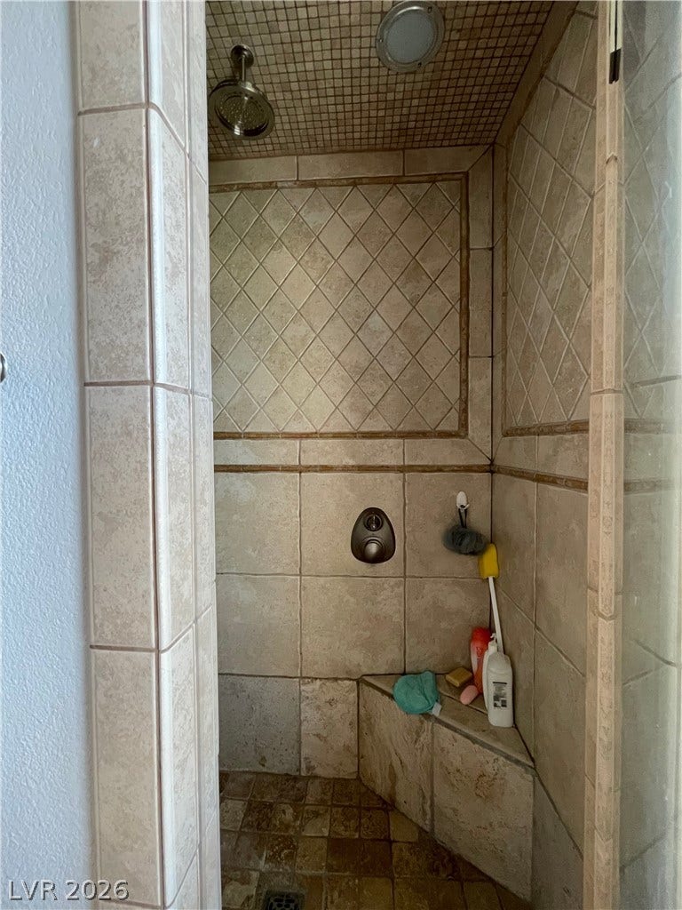 30 Via Vasari, #102, Henderson, NV 89011 Elegant tilework and a built-in corner bench define this walk-in shower.