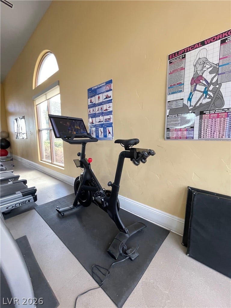 30 Via Vasari, #102, Henderson, NV 89011 Sunlight pours through large arched windows into a dedicated exercise room featuring high ceilings.