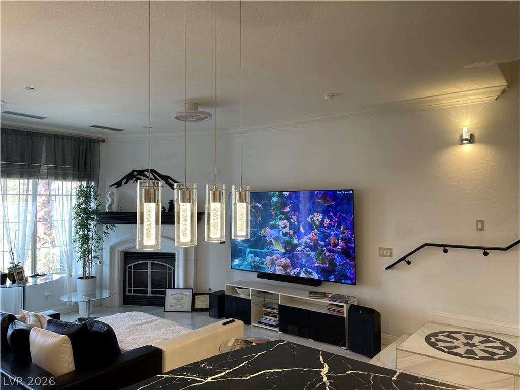 30 Via Vasari, #102, Henderson, NV 89011 Gleaming tile floors and a classic fireplace define this welcoming open living space.
