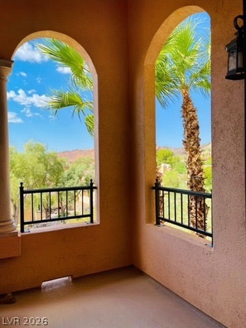 30 Via Vasari, #102, Henderson, NV 89011 Arched openings frame scenic mountain and palm tree views from this elevated balcony.