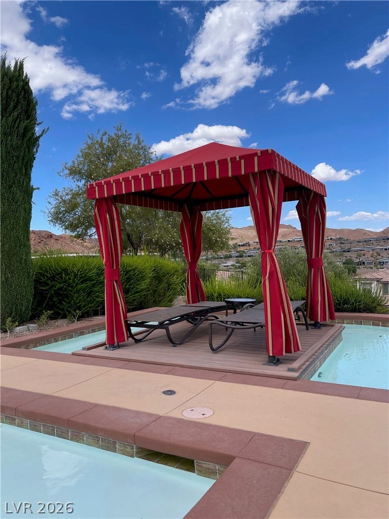 30 Via Vasari, #102, Henderson, NV 89011 An inviting poolside cabana stands ready for relaxation alongside a sparkling in-ground pool.