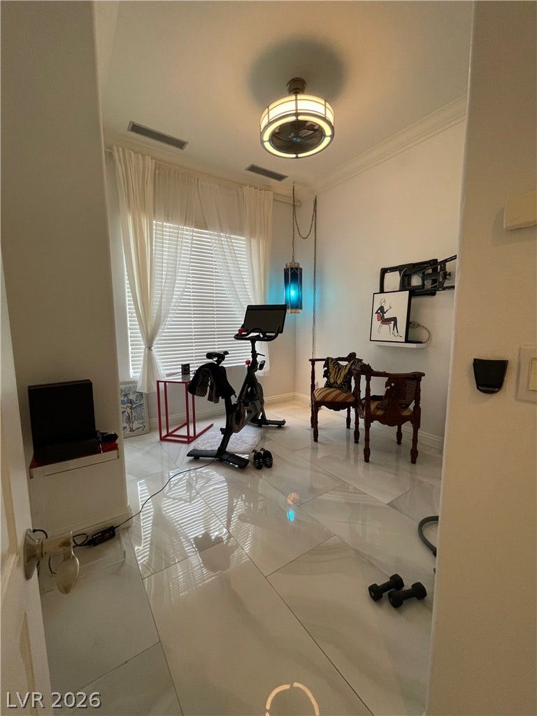 30 Via Vasari, #102, Henderson, NV 89011 Gleaming tile floors reflect light pouring through a large window under high ceilings.