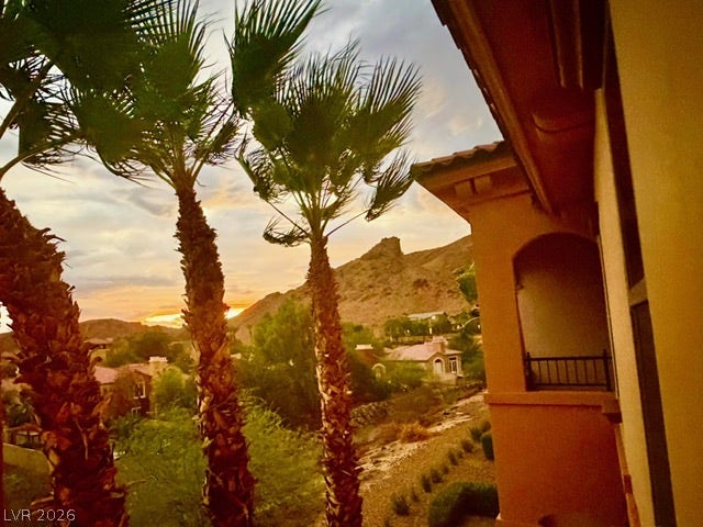 30 Via Vasari, #102, Henderson, NV 89011 Dramatic desert sunset views framed by palm trees unfold from this elevated perspective.