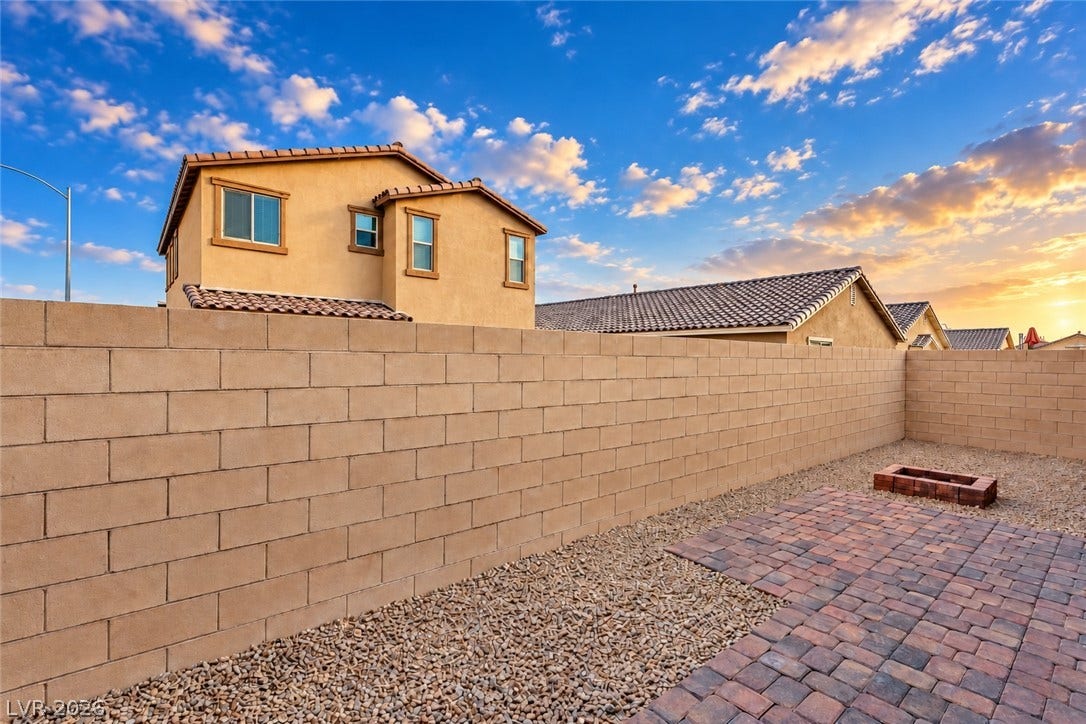 5740 Saltrock Grove Street, North Las Vegas, NV 89081 A spacious backyard area features brick paver flooring and a low-maintenance gravel ground cover.
