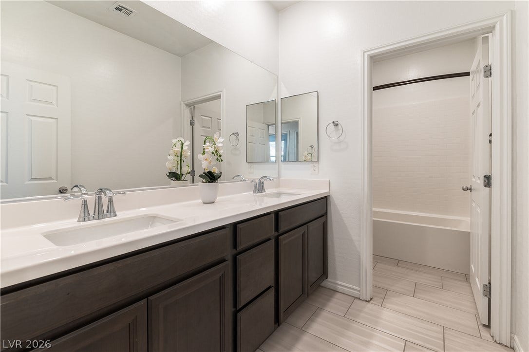 5740 Saltrock Grove Street, North Las Vegas, NV 89081 Clean lines and durable tile flooring define this functional vanity space.