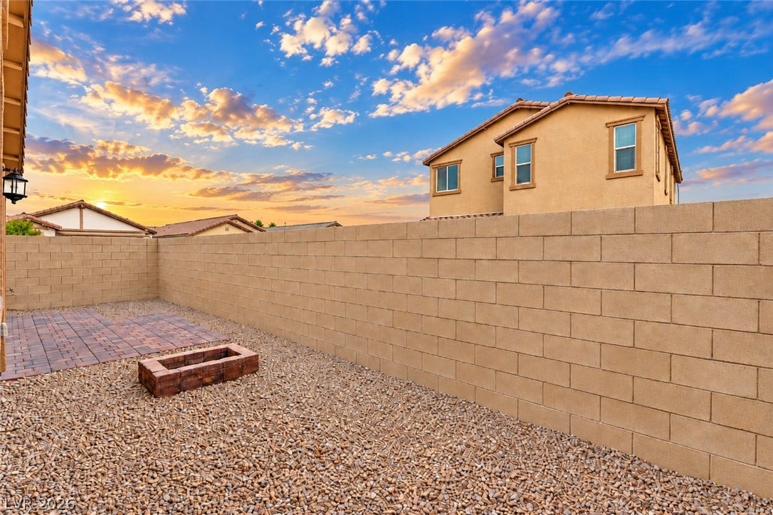 5740 Saltrock Grove Street, North Las Vegas, NV 89081 A block privacy wall encloses this low-maintenance yard complete with a paver patio.