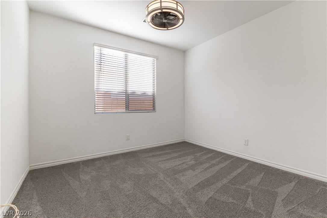 5740 Saltrock Grove Street, North Las Vegas, NV 89081 A window with built-in blinds illuminates a bedroom featuring soft carpeting.