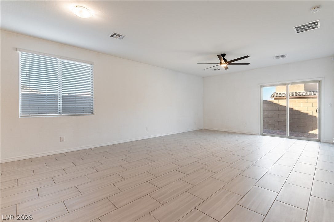 5740 Saltrock Grove Street, North Las Vegas, NV 89081 Clean tile flooring and a wide sliding glass door define this versatile living area.
