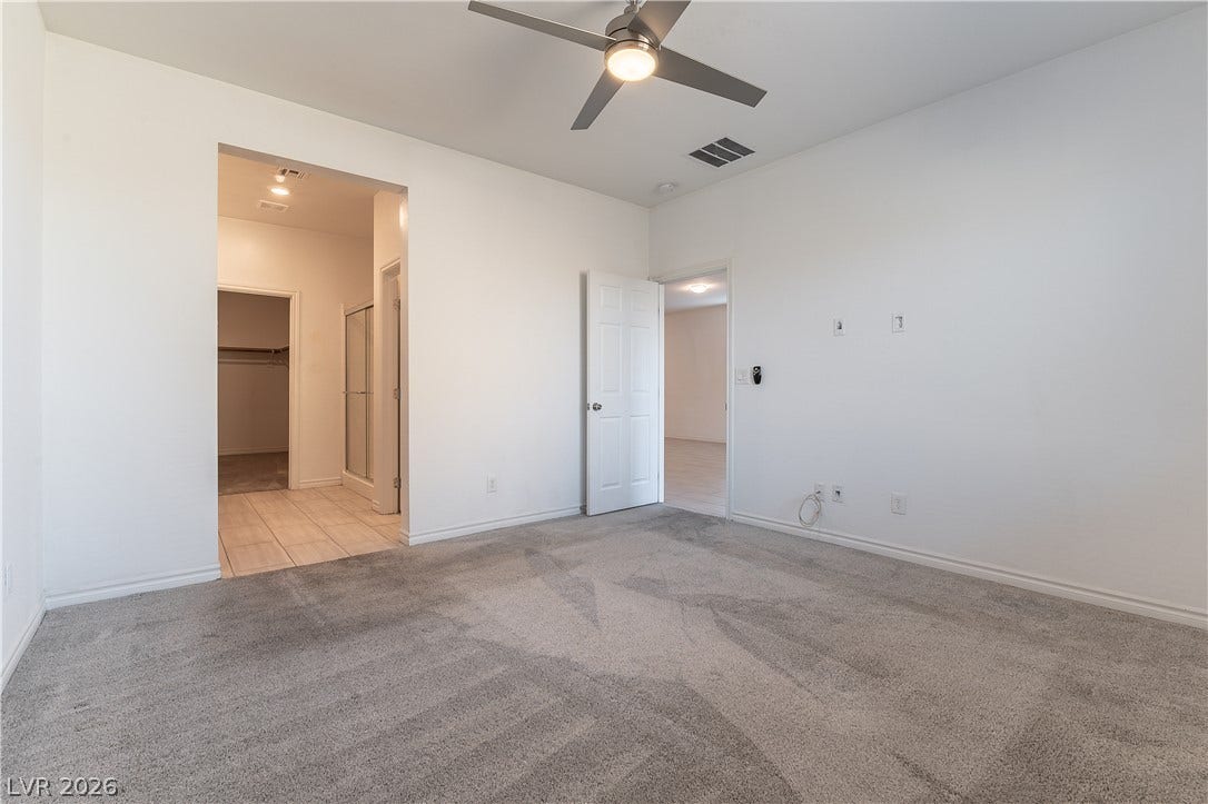 5740 Saltrock Grove Street, North Las Vegas, NV 89081 Plush carpeting and an open doorway leading to the private bathroom highlight this bedroom.