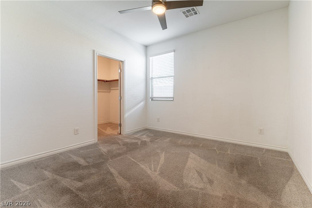 5740 Saltrock Grove Street, North Las Vegas, NV 89081 Plush carpeting and a walk-in closet highlight this comfortable bedroom space.