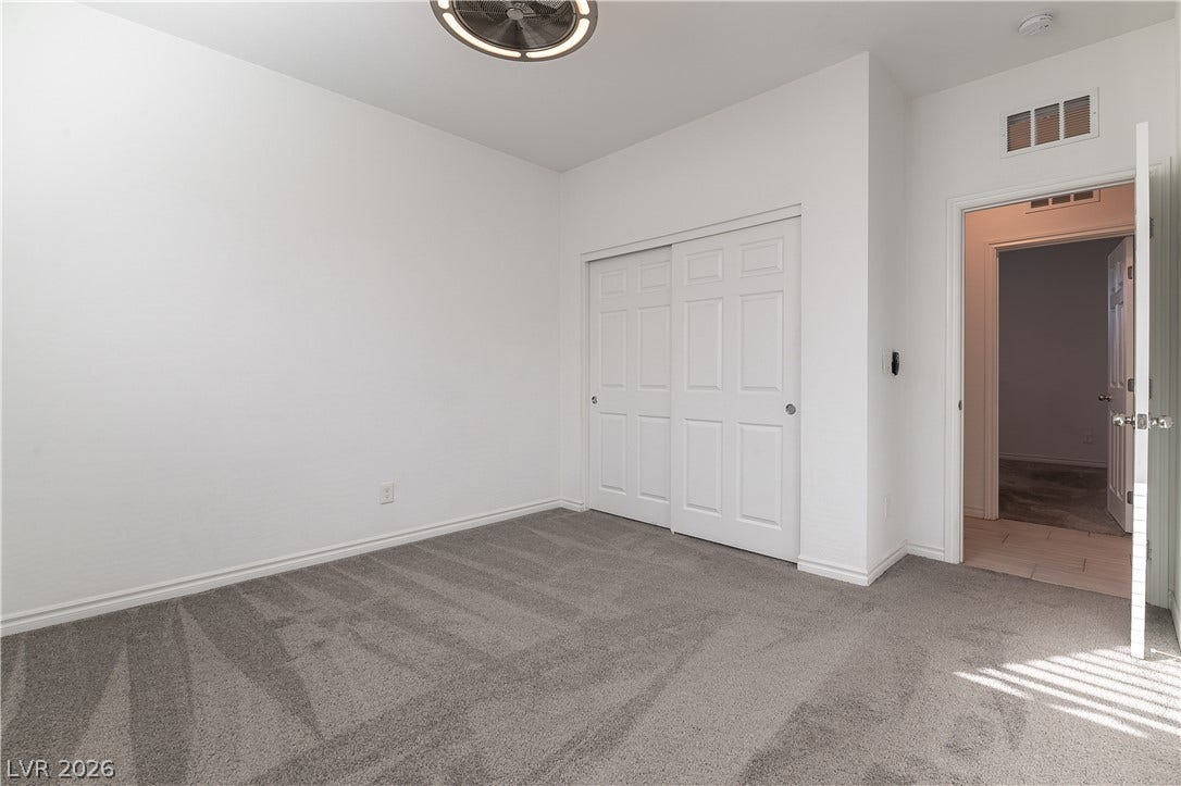 5740 Saltrock Grove Street, North Las Vegas, NV 89081 Plush wall-to-wall carpeting and neutral tones define this versatile secondary bedroom space.