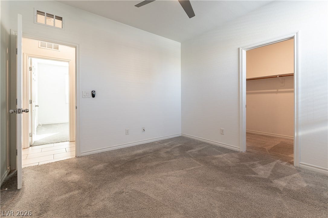 5740 Saltrock Grove Street, North Las Vegas, NV 89081 Plush carpeting and crisp white walls define this comfortable second-floor bedroom.
