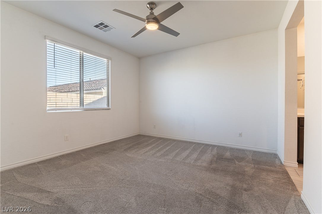 5740 Saltrock Grove Street, North Las Vegas, NV 89081 Plush carpet and a large window create a comfortable and inviting atmosphere.